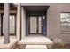 Modern townhome exterior with brick and siding, featuring a covered entryway at 9893 Greenvine Dr, Carmel, IN 46032