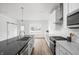 Modern kitchen with white cabinets, large island, and stainless steel appliances at 9893 Greenvine Dr, Carmel, IN 46032