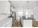 Open concept kitchen with white cabinets and large kitchen island at 9893 Greenvine Dr, Carmel, IN 46032