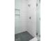 Clean shower with white subway tile and hexagon floor tile at 9893 Greenvine Dr, Carmel, IN 46032