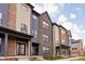 Row of modern townhomes showcasing brick and contrasting siding at 9893 Greenvine Dr, Carmel, IN 46032