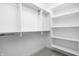 Spacious walk-in closet with shelves and hanging rods at 9893 Greenvine Dr, Carmel, IN 46032