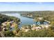 Breathtaking aerial view of a lake community surrounded by lush trees and featuring beautiful waterfront homes at 10841 W Grandview Dr, Columbus, IN 47201