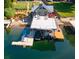 Aerial view of waterfront home with boat dock, boat lifts, and hot tub at 10841 W Grandview Dr, Columbus, IN 47201