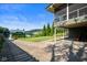 View of backyard with screened porch and a glimpse of the lake, providing an idyllic outdoor setting at 10841 W Grandview Dr, Columbus, IN 47201