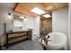 Stylish bathroom featuring a freestanding tub, glass-enclosed shower, and wood accents at 10841 W Grandview Dr, Columbus, IN 47201