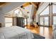 Bedroom featuring high ceilings, wood beams, a fireplace, and water views at 10841 W Grandview Dr, Columbus, IN 47201