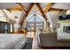 Spacious main bedroom featuring high ceilings, wood beams, a fireplace, and water views at 10841 W Grandview Dr, Columbus, IN 47201