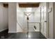 Bright hallway with a skylight, dark tile floor, and decorative antler art at 10841 W Grandview Dr, Columbus, IN 47201