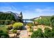 Well-manicured landscaping frames this home with a stone walkway leading to the waterfront at 10841 W Grandview Dr, Columbus, IN 47201