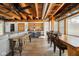 Open living space with exposed wood ceiling beams, dining area and stainless steel kitchen at 10841 W Grandview Dr, Columbus, IN 47201