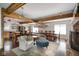 Spacious living room features exposed beams, wood floors, and a cozy sitting area at 10841 W Grandview Dr, Columbus, IN 47201