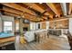 Open living space with exposed wood ceiling beams, fireplace, kitchen and dining area at 10841 W Grandview Dr, Columbus, IN 47201