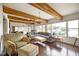 Bright living area with exposed wood beams, hardwood floors, and a view of the lake at 10841 W Grandview Dr, Columbus, IN 47201