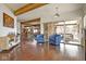 Open-concept living room with exposed beams, wood floors, and a view to an outdoor patio at 10841 W Grandview Dr, Columbus, IN 47201