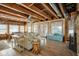 Living area with an exposed ceiling, stone fireplace, comfortable seating, and water views at 10841 W Grandview Dr, Columbus, IN 47201