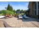 Well manicured backyard patio with outdoor seating, a firepit, and lush landscaping at 10841 W Grandview Dr, Columbus, IN 47201