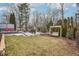 A well-maintained lawn, complemented by a cozy swing set, outdoor fireplace, and deck with seating at 10842 Belmont Cir, Indianapolis, IN 46280
