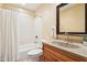 Clean bathroom with a tiled shower/tub combination and a wooden vanity with counter sink at 10842 Belmont Cir, Indianapolis, IN 46280