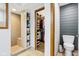 Bathroom featuring a walk-in shower, toilet, and an adjacent walk-in closet with shelving at 10842 Belmont Cir, Indianapolis, IN 46280
