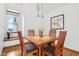 Bright dining room featuring a window seat, hardwood floors, and stylish furniture at 10842 Belmont Cir, Indianapolis, IN 46280