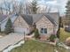 Well-manicured lawn and landscaping complement this charming brick home with a two-car garage at 10842 Belmont Cir, Indianapolis, IN 46280