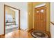 Foyer features hardwood floors, a wooden front door, and views into an office at 10842 Belmont Cir, Indianapolis, IN 46280