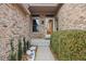 Front entrance featuring a brick facade, trimmed bushes and small garden at 10842 Belmont Cir, Indianapolis, IN 46280