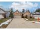 Charming brick home featuring a driveway, attached garage, and manicured landscaping at 10842 Belmont Cir, Indianapolis, IN 46280