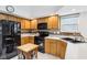 Kitchen featuring wood cabinets, black appliances, and butcher block island at 10842 Belmont Cir, Indianapolis, IN 46280