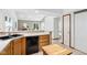 Kitchen with wood cabinets, island cart, and view to adjoining room at 10842 Belmont Cir, Indianapolis, IN 46280