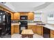 Kitchen featuring wood cabinets, black appliances, and butcher block island at 10842 Belmont Cir, Indianapolis, IN 46280
