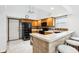 Well-lit kitchen featuring light wood cabinets, black appliances, breakfast bar with seating, and tiled backsplash at 10842 Belmont Cir, Indianapolis, IN 46280