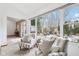 Inviting living area with a large window overlooking a backyard patio featuring an outdoor fireplace at 10842 Belmont Cir, Indianapolis, IN 46280