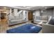 Finished basement with cozy seating, wood-look floors, and ample space at 128 Wellington Rd, Indianapolis, IN 46260