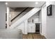 Basement area featuring a stylish wet bar with a wine fridge, cabinets and unique under-stair storage at 128 Wellington Rd, Indianapolis, IN 46260