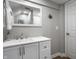 Bathroom with a modern sink, vanity, large mirror, white door and neutral gray walls at 128 Wellington Rd, Indianapolis, IN 46260