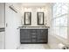 Beautiful bathroom featuring double sinks with sleek gray cabinets and modern fixtures at 128 Wellington Rd, Indianapolis, IN 46260
