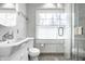 Bright bathroom with glass shower, white fixtures, and granite accents at 128 Wellington Rd, Indianapolis, IN 46260