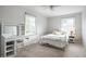 Cozy bedroom with neutral carpet, desk, and comfortable white metal frame bed at 128 Wellington Rd, Indianapolis, IN 46260