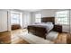 Serene bedroom featuring hardwood floors, natural light, a neutral color scheme, and a cozy rug at 128 Wellington Rd, Indianapolis, IN 46260