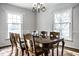 Formal dining room with a hardwood floor and traditional chandelier fixture at 128 Wellington Rd, Indianapolis, IN 46260