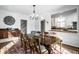 Elegant dining room with hardwood floors, decorative rug, stylish lighting and convenient kitchen access at 128 Wellington Rd, Indianapolis, IN 46260