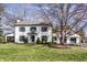 Charming two-story home features a well-manicured lawn and inviting curb appeal at 128 Wellington Rd, Indianapolis, IN 46260
