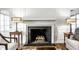 Inviting fireplace flanked by stylish lamps and views from the nearby doors and windows at 128 Wellington Rd, Indianapolis, IN 46260