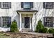 Welcoming front entrance with a stylish door, complemented by manicured shrubs at 128 Wellington Rd, Indianapolis, IN 46260