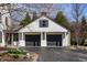 Exterior view of a two-car garage with dark doors, white siding and the house number clearly visible at 128 Wellington Rd, Indianapolis, IN 46260