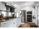 Chef's kitchen featuring stainless appliances, granite counters, custom cabinets, and hardwood floors at 128 Wellington Rd, Indianapolis, IN 46260