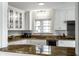 Bright kitchen with custom cabinets, granite countertops, stainless steel appliances, and window view at 128 Wellington Rd, Indianapolis, IN 46260