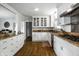 Gourmet kitchen with granite countertops, white cabinets, stainless steel appliances, and hardwood floors at 128 Wellington Rd, Indianapolis, IN 46260
